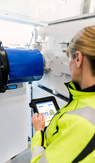 Engineer taking condition monitoring readings from a hand-held screen