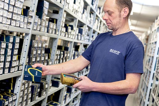 Warehouse worker picking bearings off a shelf