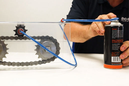 Image of man pressing aerosol lubrication attached to a RotaLube inaccessible lubrication kit