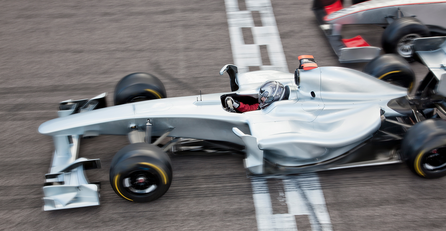 Motorsport team racing across the finish line