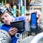 Engineer taking a pulse reading of an electric motor with the SKF CMDT39x-K-SL QuickCollect Plug & Play Sensor